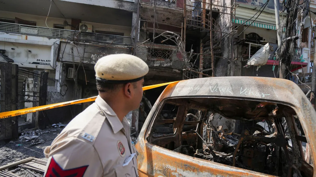 Policemen outside a children's hospital where a fire broke out on Saturday night at Vivek Vihar area, in New Delhi, Sunday, May 26, 2024