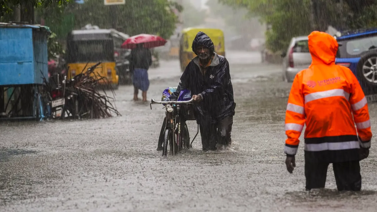 A commuter on a waterlogged road during heavy rain owing to Cyclone Michaung, in Chennai