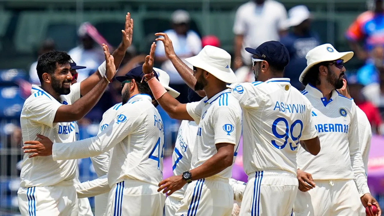Jasprit Bumrah celebrates with teammates after taking the wicket of Bangladesh's Mushfiqur Rahim on the second day of the first test cricket match, in Chennai, Friday, Sept. 20, 2024.