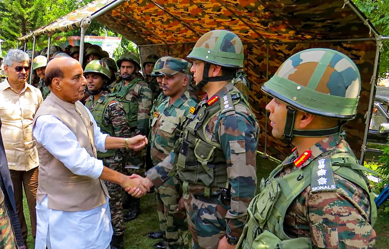Defence Minister Rajnath Singh interacts with security personnel during his visit to Army Base Camp in Rajouri