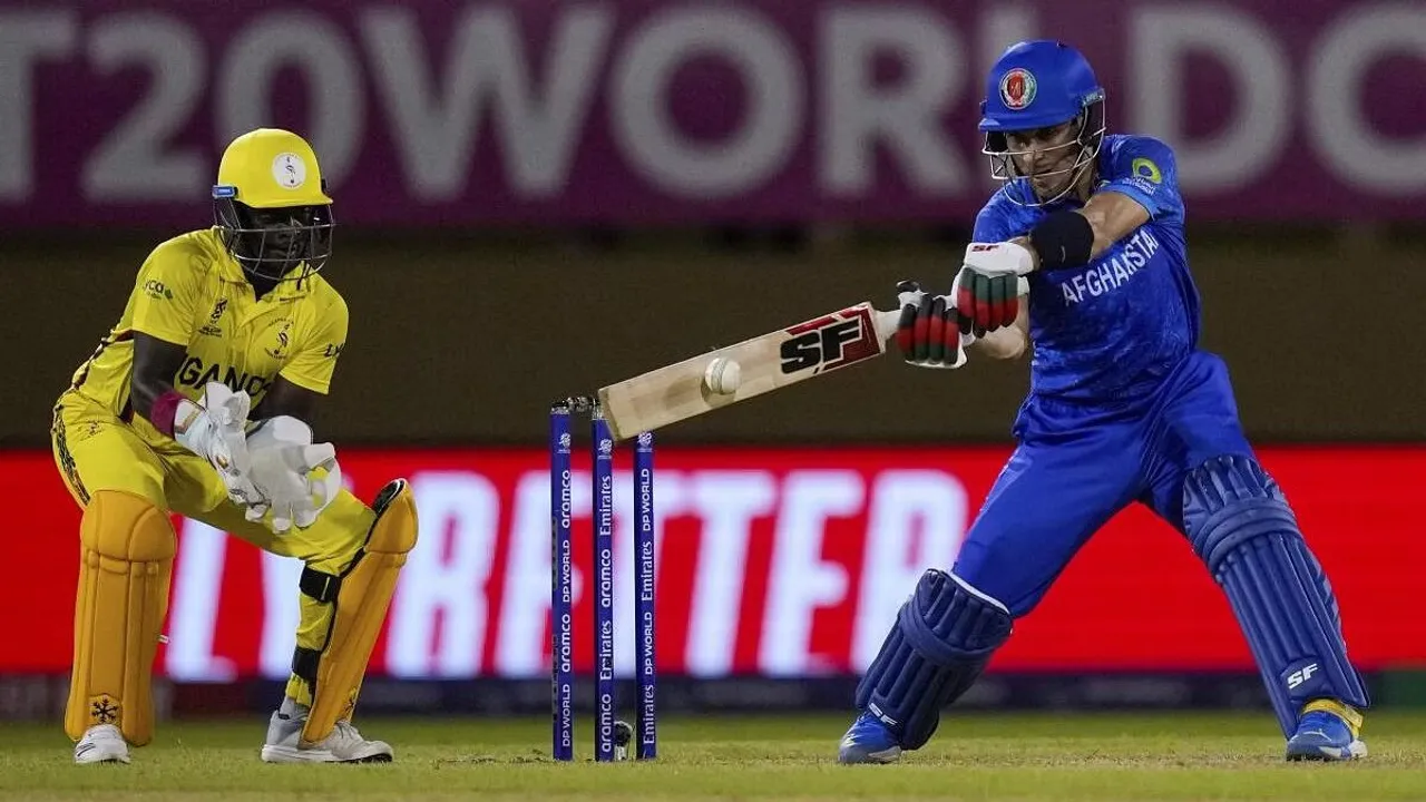 Afghanistan's Rahmanullah Gurbaz, right, plays a shot as Uganda's wicket keeper Simon Ssesazi looks on during an ICC Men's T20 World Cup cricket match at Guyana National Stadium in Providence, Guyana, Monday, June 3, 2024
