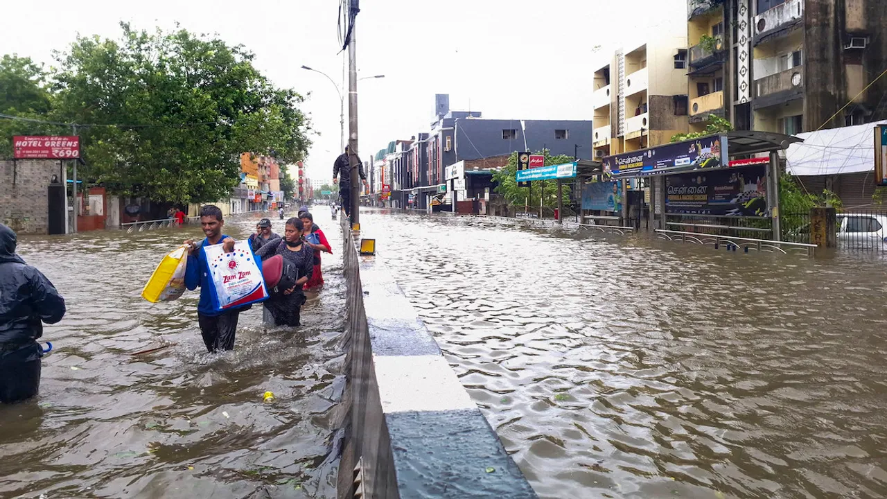 People wade through a waterlogged road during heavy rain owing to Cyclone Michaung, in Chennai, Monday, Dec. 4, 2023.