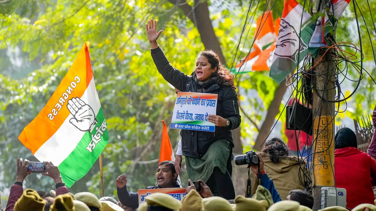 Police personnel stand guard as Congress workers protest over the IIT-BHU sexual assault case, in Lucknow