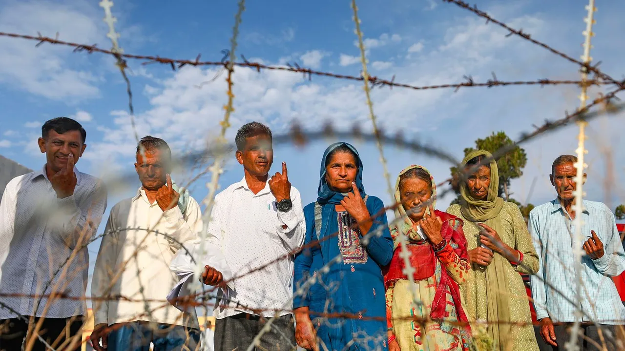 People show their inked fingers after casting their votes during the sixth phase of Lok Sabha elections, along the Line of Control (LoC) at Nowshera, in Rajouri district, Saturday, May 25, 2024