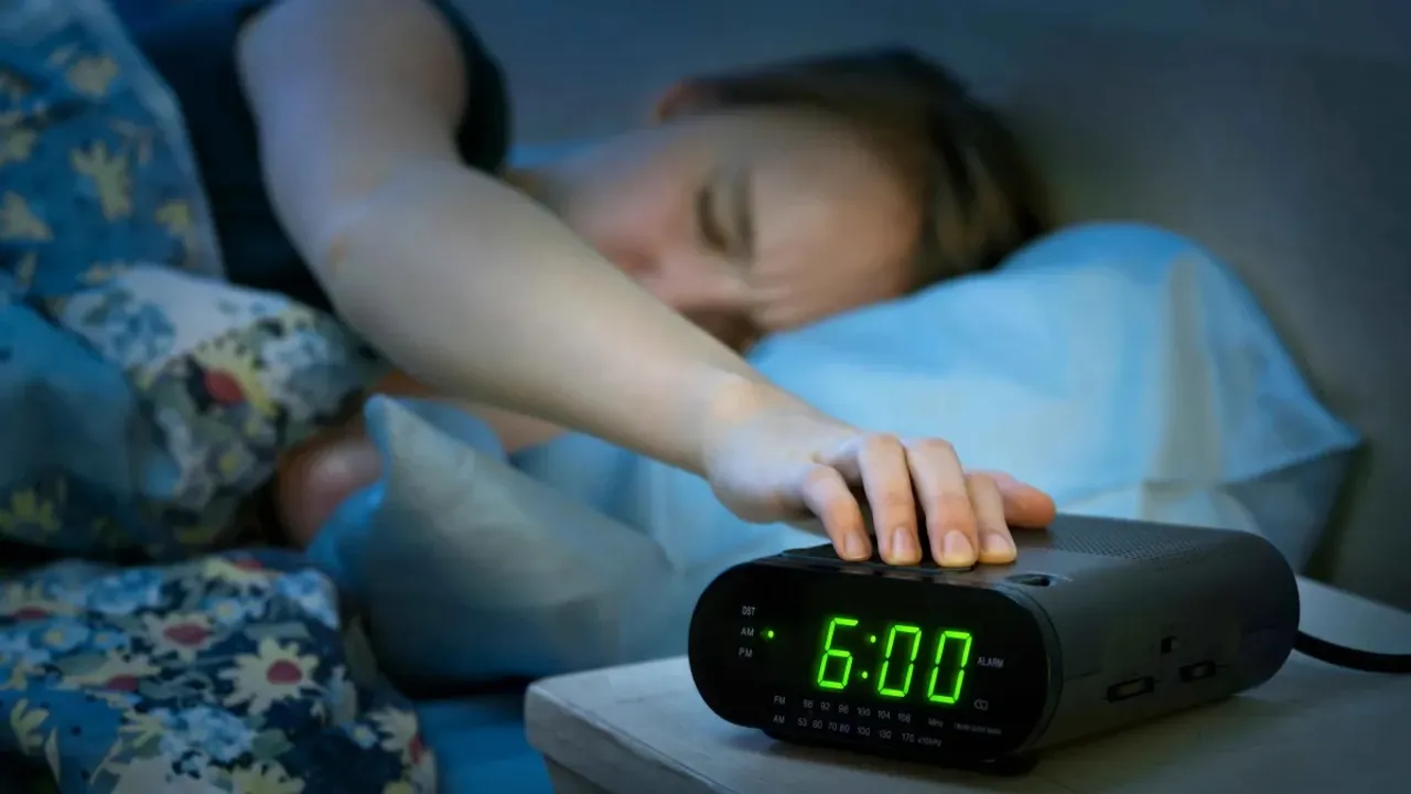 woman pressing snooze.jpg
