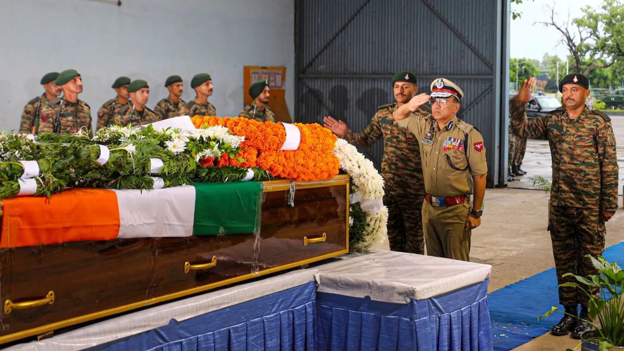 Additional Director General of Police (ADGP) Jammu Zone Anand Jain pays tribute to the mortal remains of martyred Captain Deepak Singh, who was killed in the recent terrorist encounter in Doda district, at the Air Force Station, in Jammu, Thursday, Aug. 15, 2024