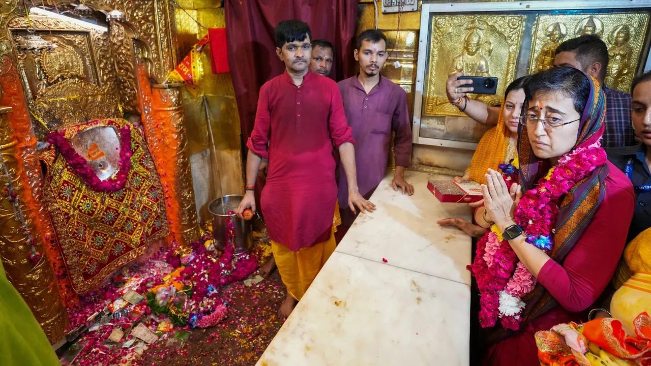 Delhi Chief Minister Atishi offers prayers during her visit at the Hanuman temple at Connaught Place, in New Delhi, Tuesday, Sept. 24, 2024.