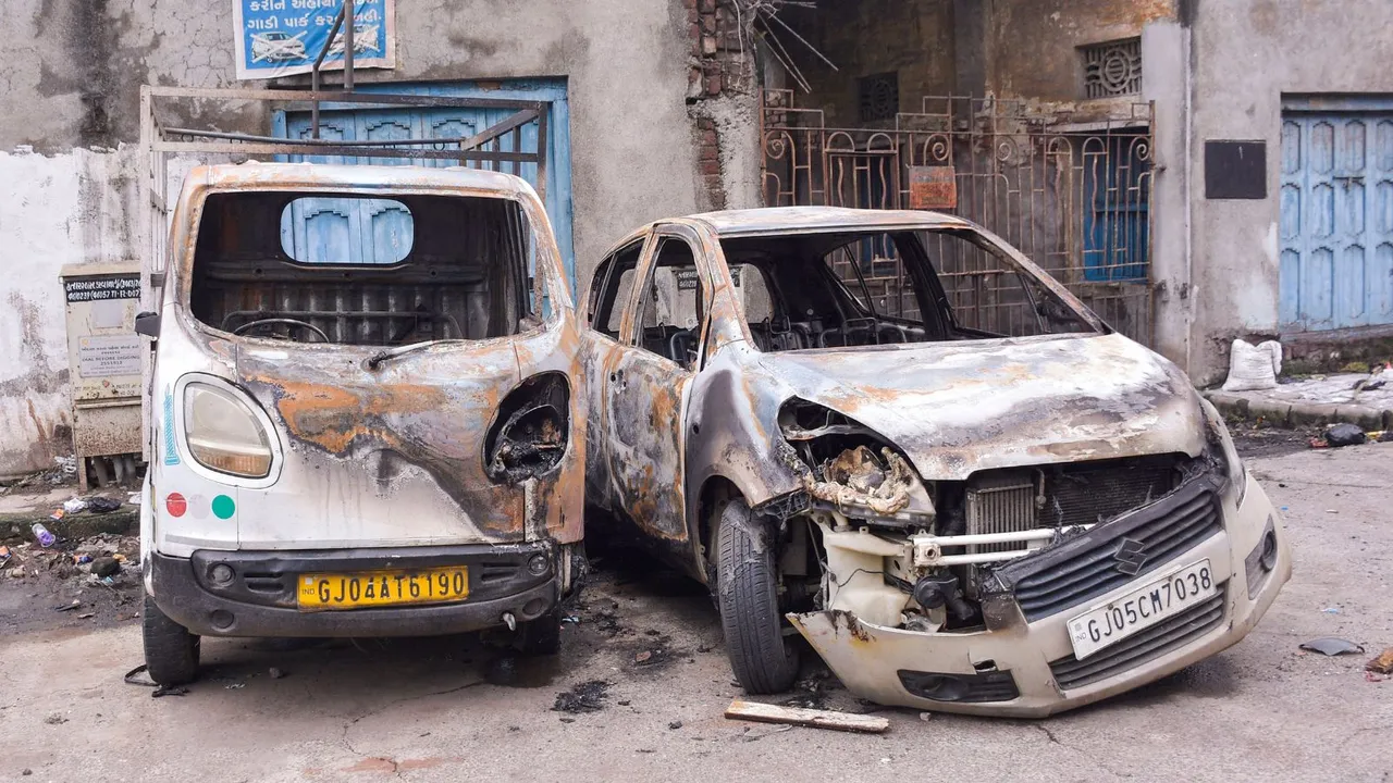 Charred remains of vehicles following a clash between two groups as an idol of Lord Ganesh was damaged after some persons allegedly threw stones at a pandal during the ongoing Ganpati festival on late Sunday night, in Surat, Monday, Sept 9, 2024.