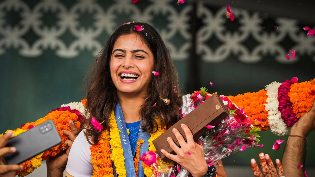 Markswoman Manu Bhaker being welcomed upon her arrival at the airport, in New Delhi, Wednesday, Aug. 7, 2024.