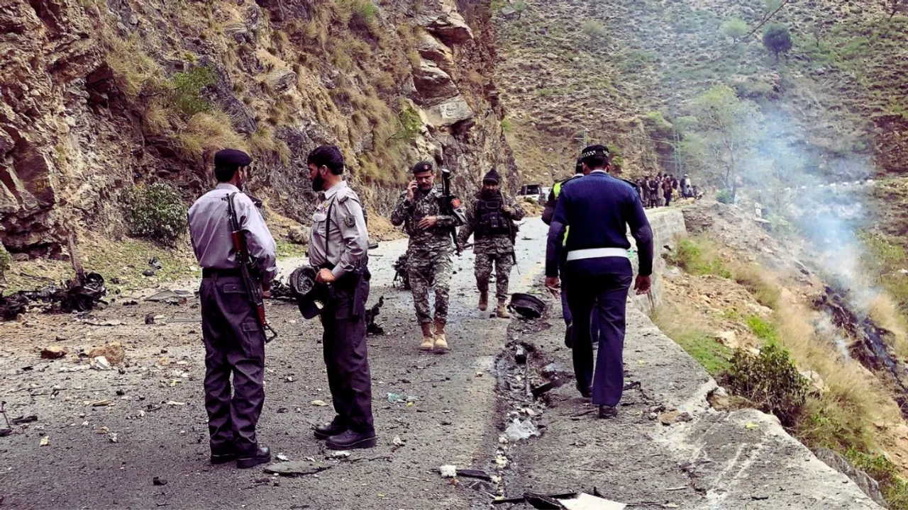 Security personnel inspect the site of a suicide attack near Besham city in the Shangla district of Khyber Pakhtunkhwa province on March 26, 2024.