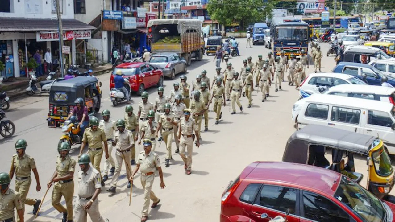 Police personnel conduct a march past in Puttur, Mangaluru, Thursday