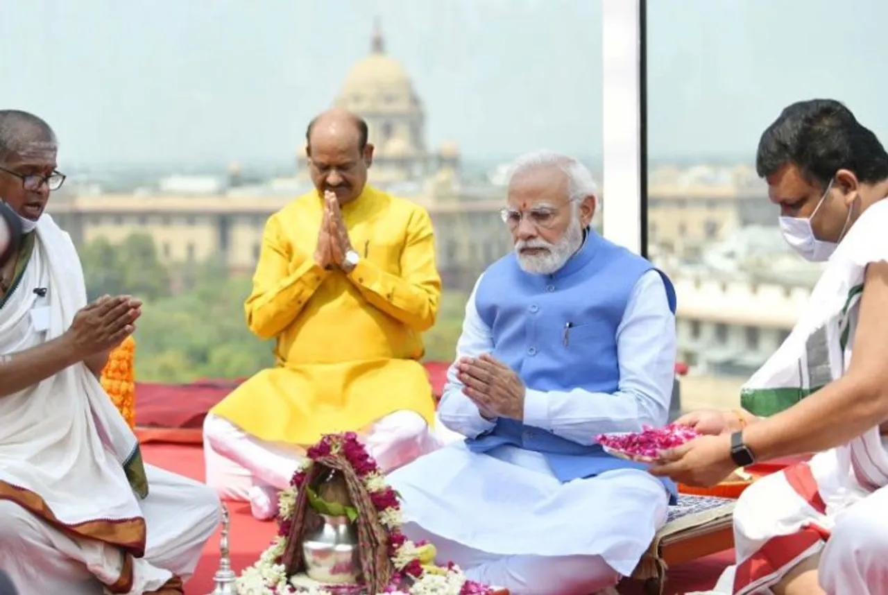 Prime Minister Narendra Modi unveils the National Emblem on the roof of India's New Parliament Building