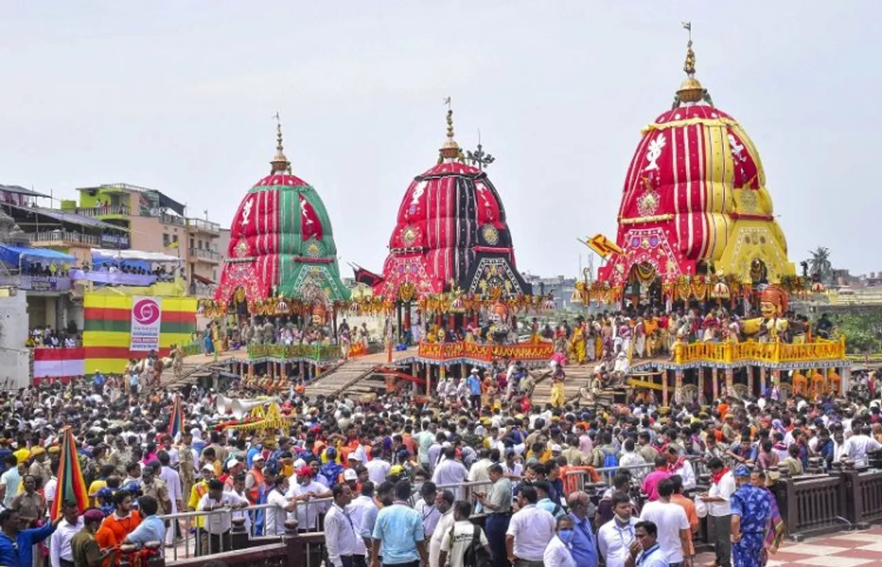 Devotees throng the chariots of Lord Jagannath, Lord Balabhadra and Goddess Subhadra during the annual Rath Yatra of Lord Jagannath, in Puri