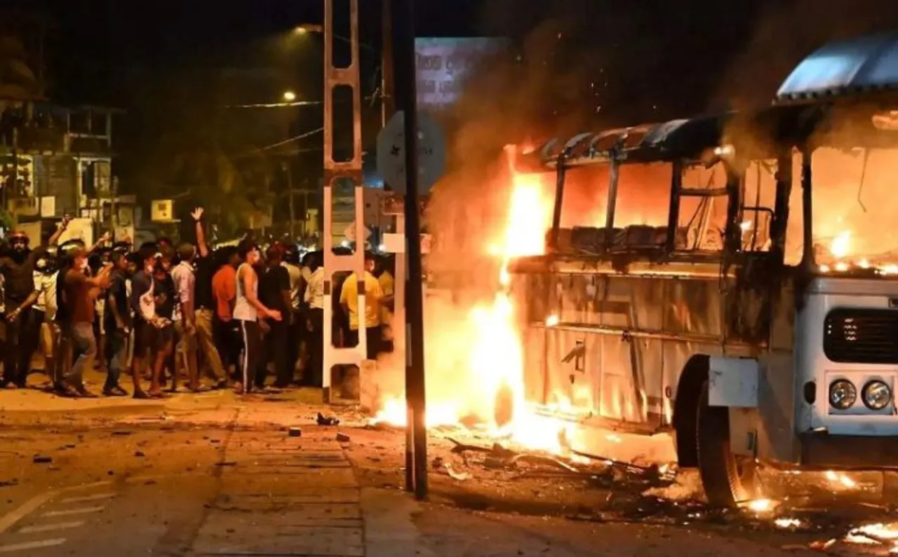 Protestors torch a bus parked nearby President's house