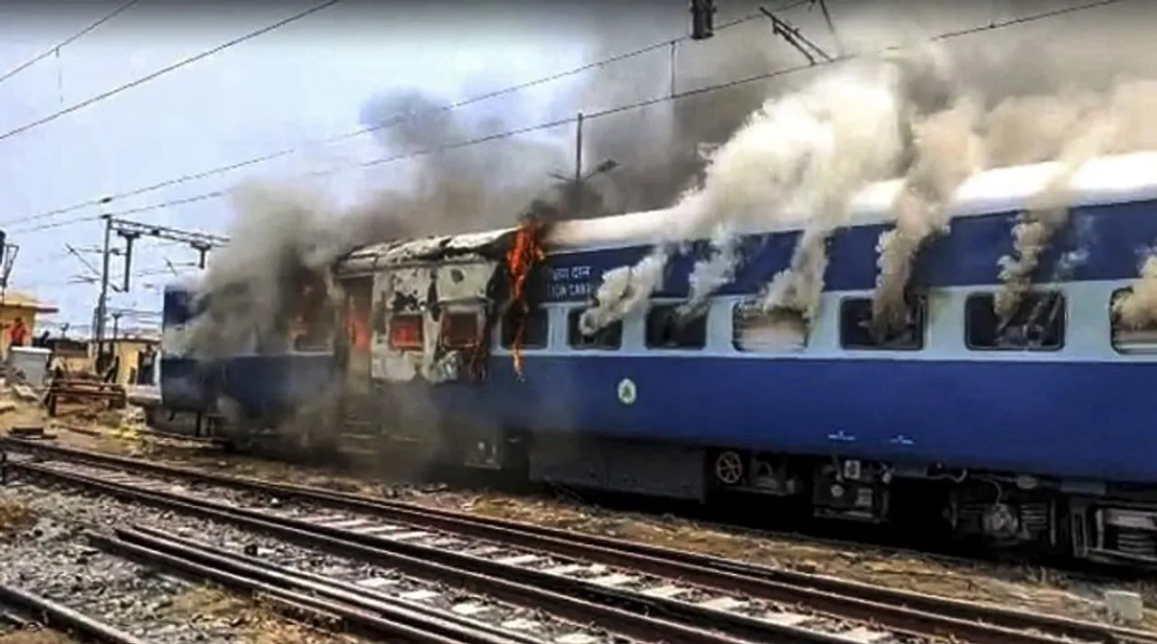 Smoke billows out after youngsters set on fire a train in protest against the Agnipath scheme, at Chapra Railway Station, in Saran district