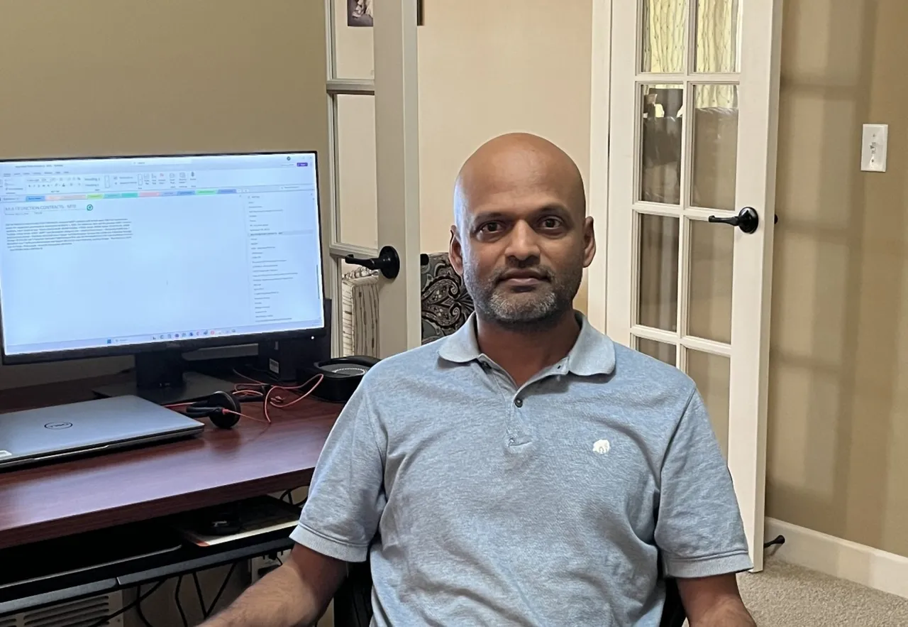 Ravikumar Palanichamy overseeing industrial ERP system with automation dashboard in background