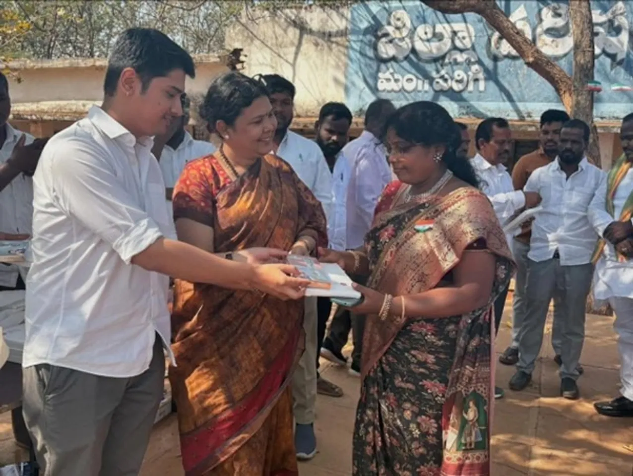 Sapan Kay Cee interacting with women and children during a community education event in India