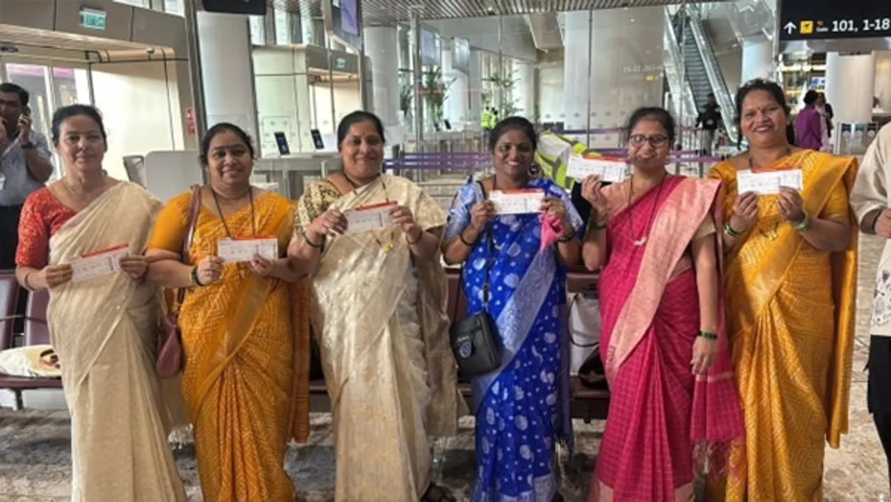 Workers, first-time flyers and veterans walking together through NMIA terminal during its people-first opening