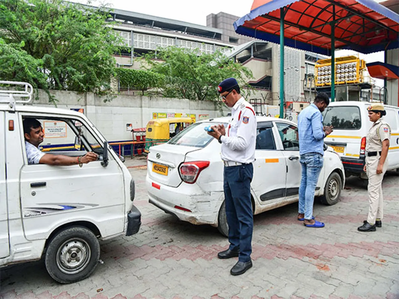 A Delhi traffic police official checks the validity of a vehicle (Photo/ANI)