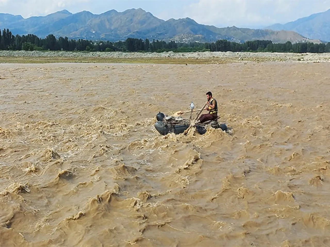 A rescue worker navigates a raft in search of survivors in Swat on June 27 (Source: Reuters)