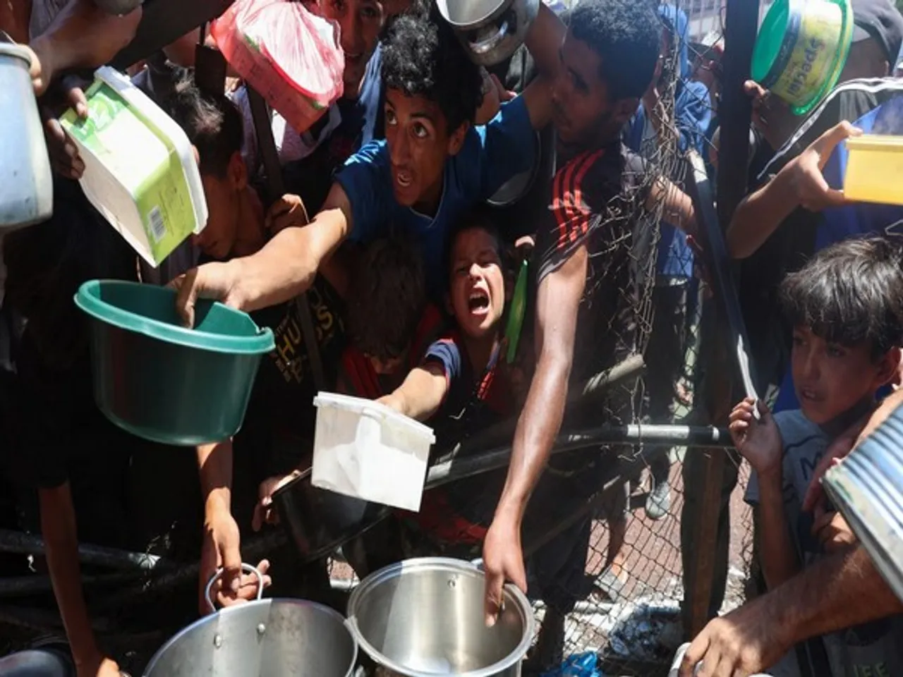 Starving Palestinians scramble for food aid in Nuseirat, central Gaza Strip, on July 20 (Source: Reuters)