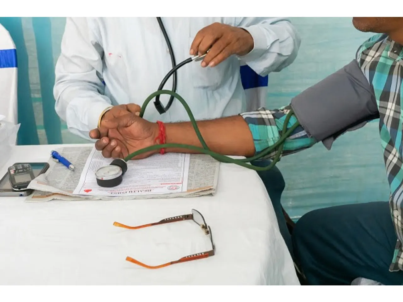 A doctor checking the blood pressure of a patient