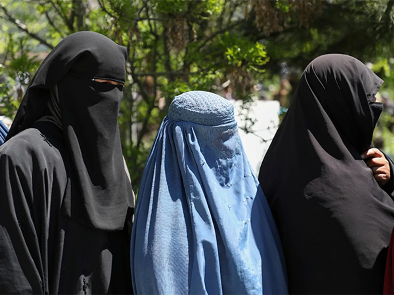 Afghan women wait to receive free wheat distributed by the government during a quarantine amid concerns over the COVID-19 pandemic (File Photo/Reuters)