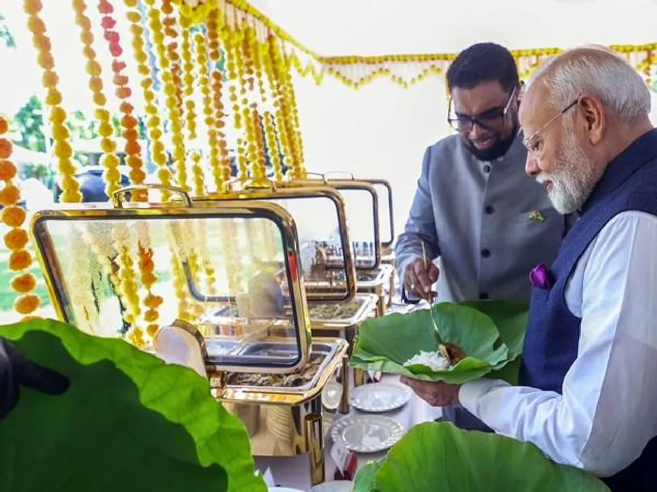 Guyana President Mohamed Irfaan Ali serves meal to PM Modi on a water lily leaf (File photo/ANI)