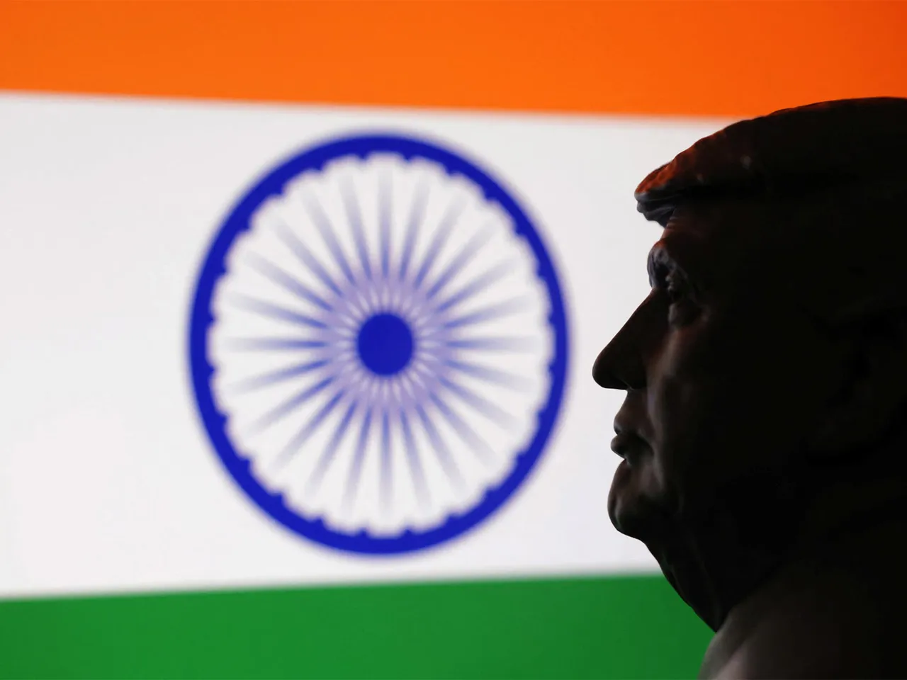 A 3D-printed miniature model of US President Donald Trump is seen alongside the Indian flag in this illustration. (Photo/Reuters)