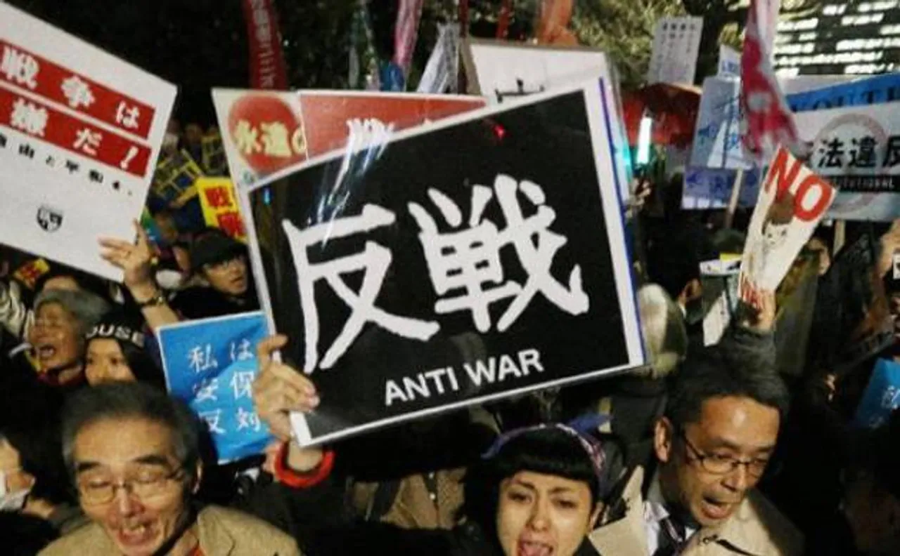 Japan defends new security laws as protesters denounce them