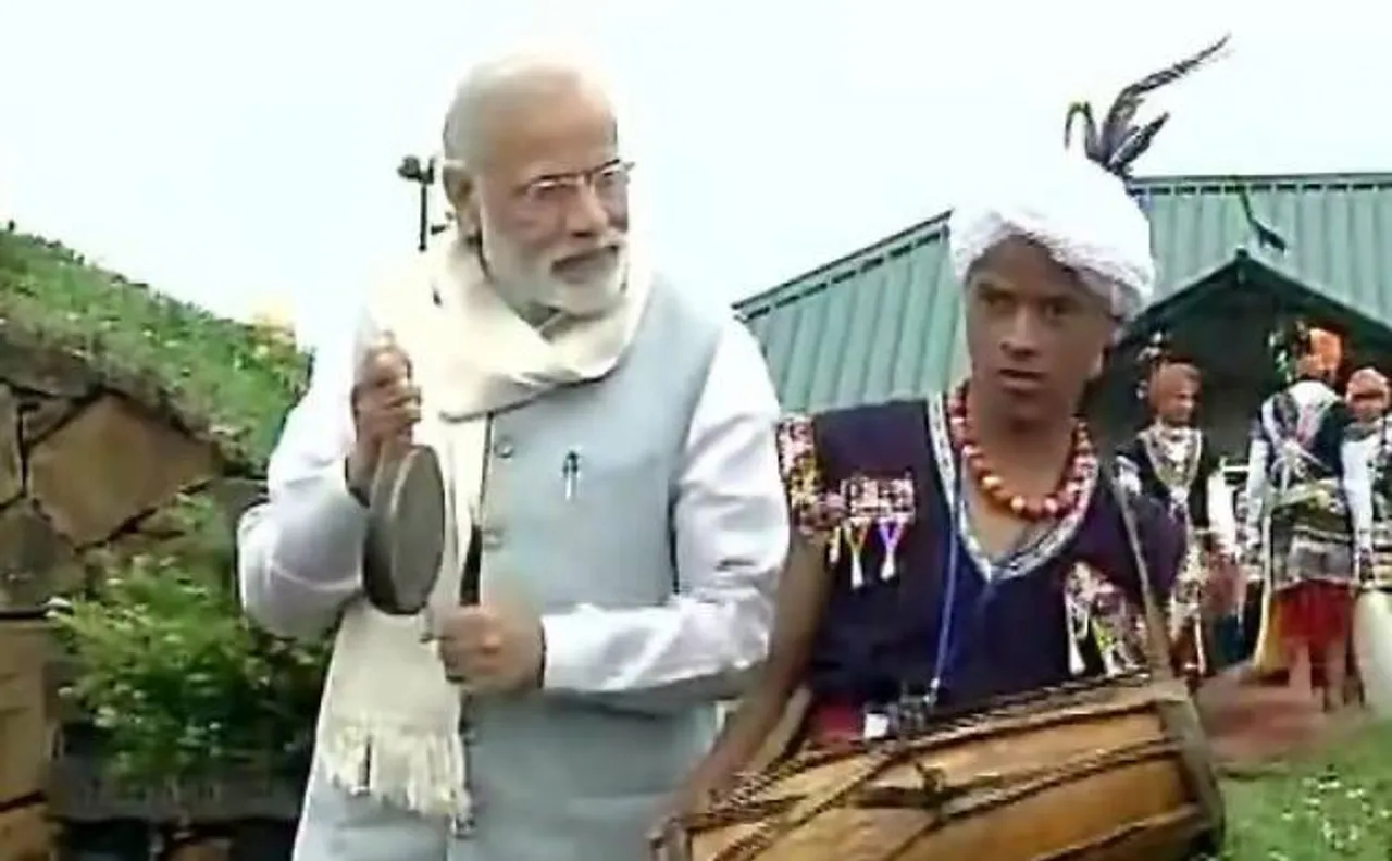 PM Narendra Modi sips tea, tries hands on drums in Meghalaya
