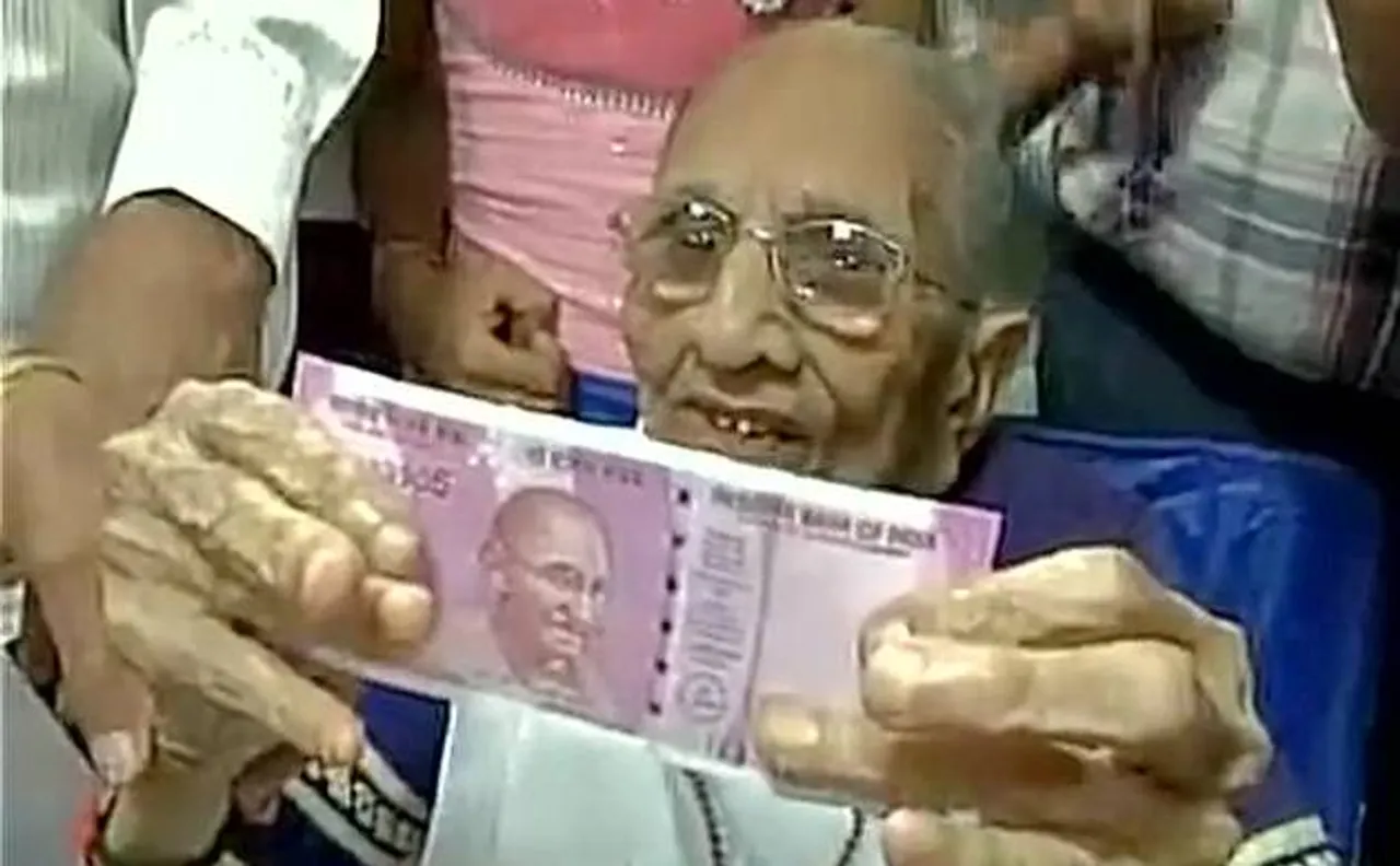 Watch: PM Modiâ€™s mother Heeraben visits bank, exchanges old notes