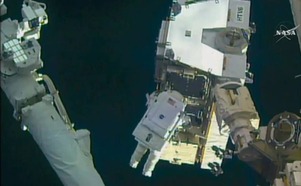 Spacewalking astronauts swap out batteries outside space station