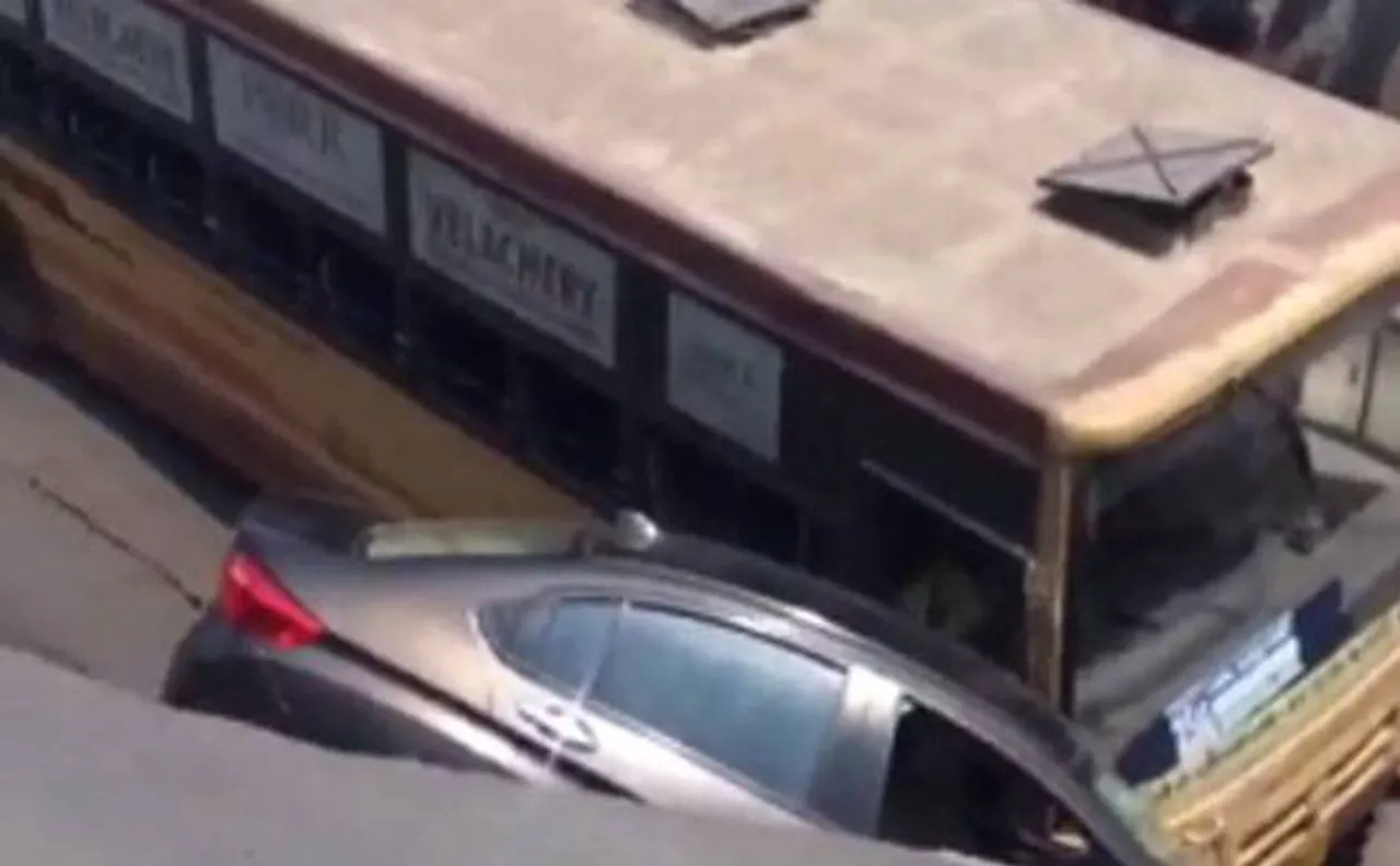 Bus, car plunge in crater as Chennai road caves in