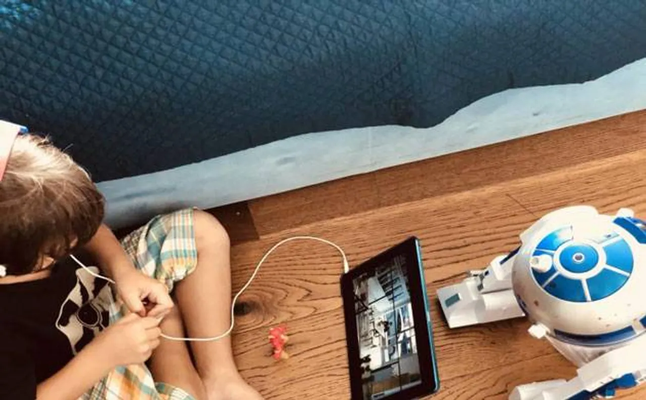 Shah Rukh Khan shares new snaps of AbRam and it makes us wonder what is he watching (see pics)