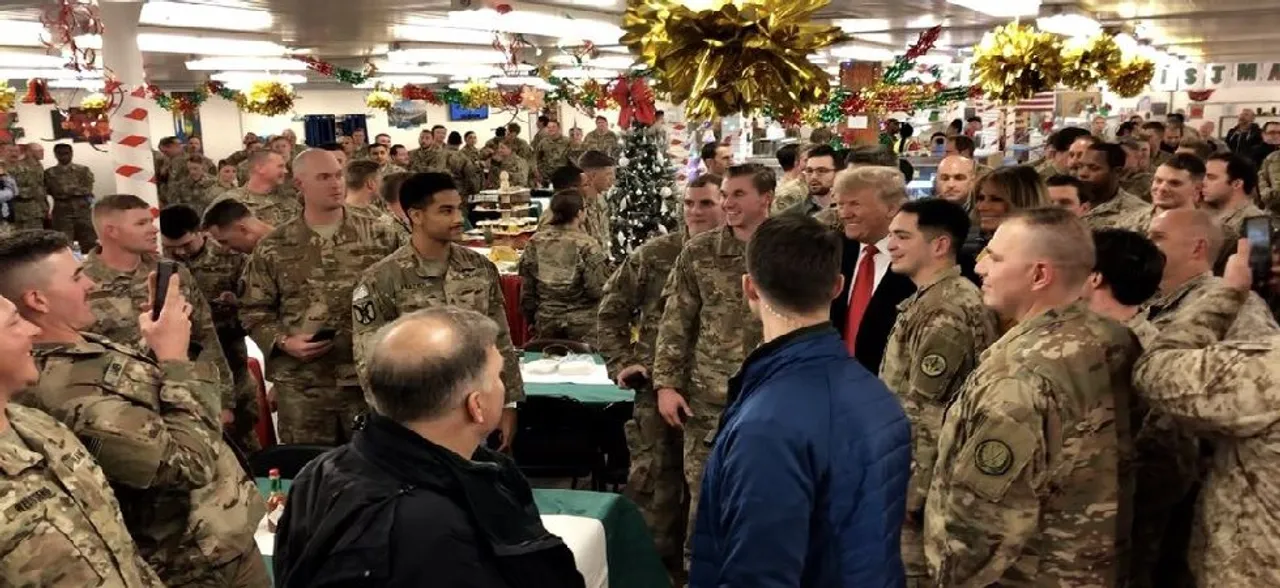 Donald Trump makes surprise visit to US troops in Iraq, defends Syria withdrawal