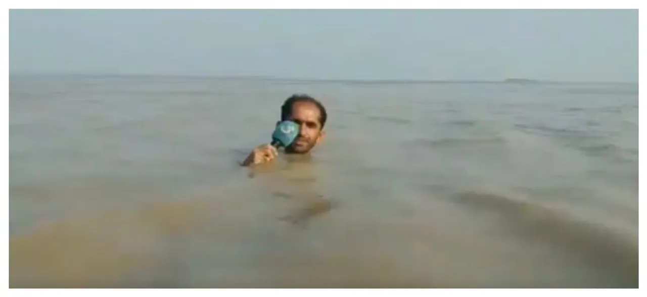 Journalist takes reporting to new depths, reports news of flood standing in â€˜neck-deepâ€™ water, WATCH