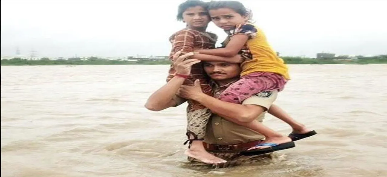 Man carries two kids on shoulders for over 1.5 km in flood-hit Gujarat, wins accolades
