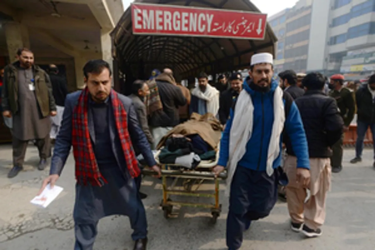 People transfer a man injured in Bajaur blast to a hospital in northwest Pakistan's Peshawar