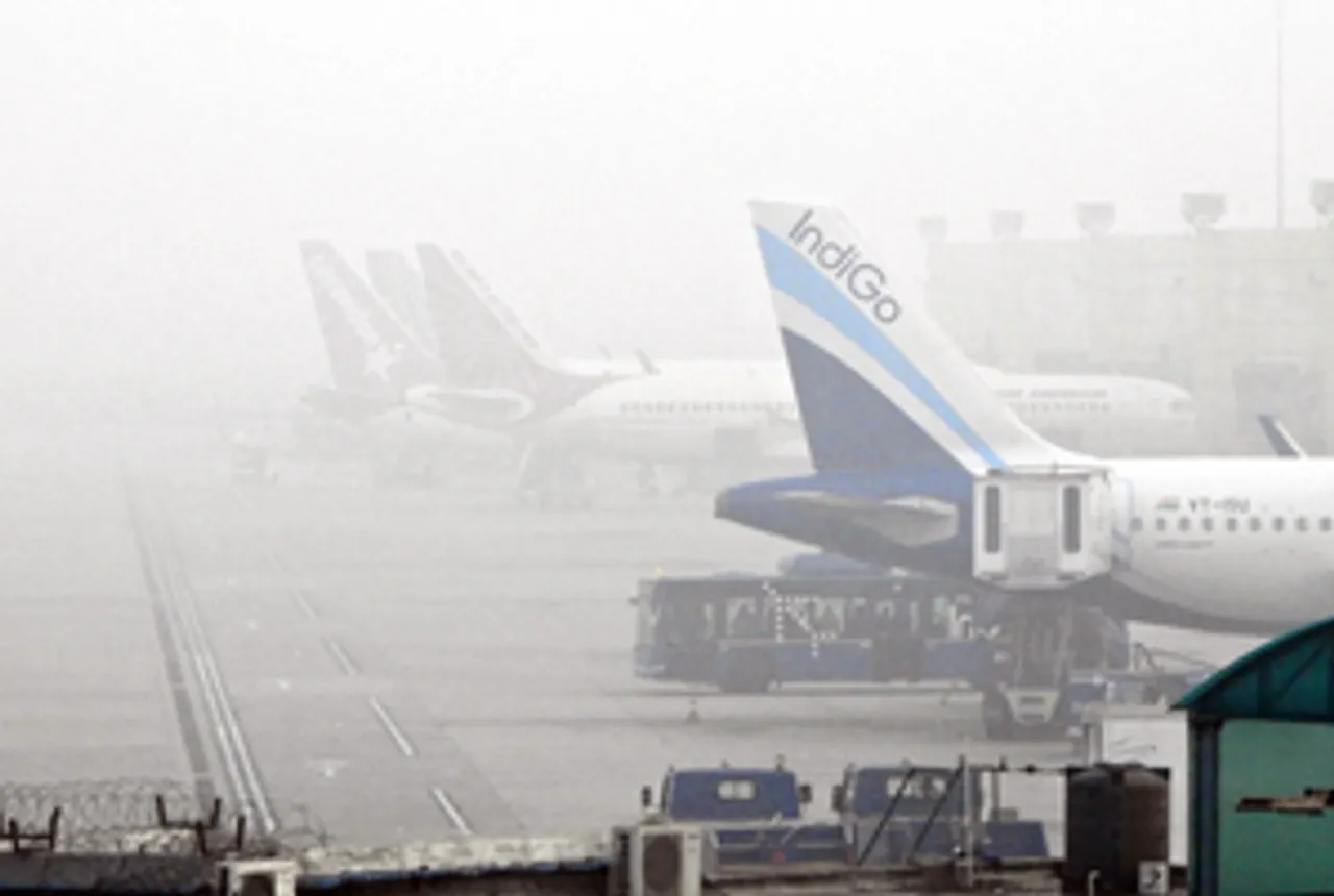 New Delhi: Partially visible airplanes at the airport amidst fog