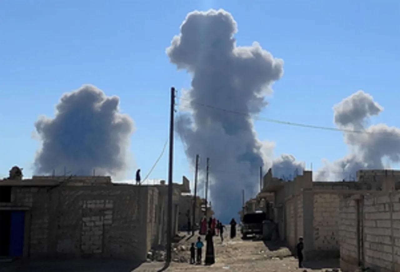 Smoke caused by an Israeli missile attack rises from the city of Palmyra