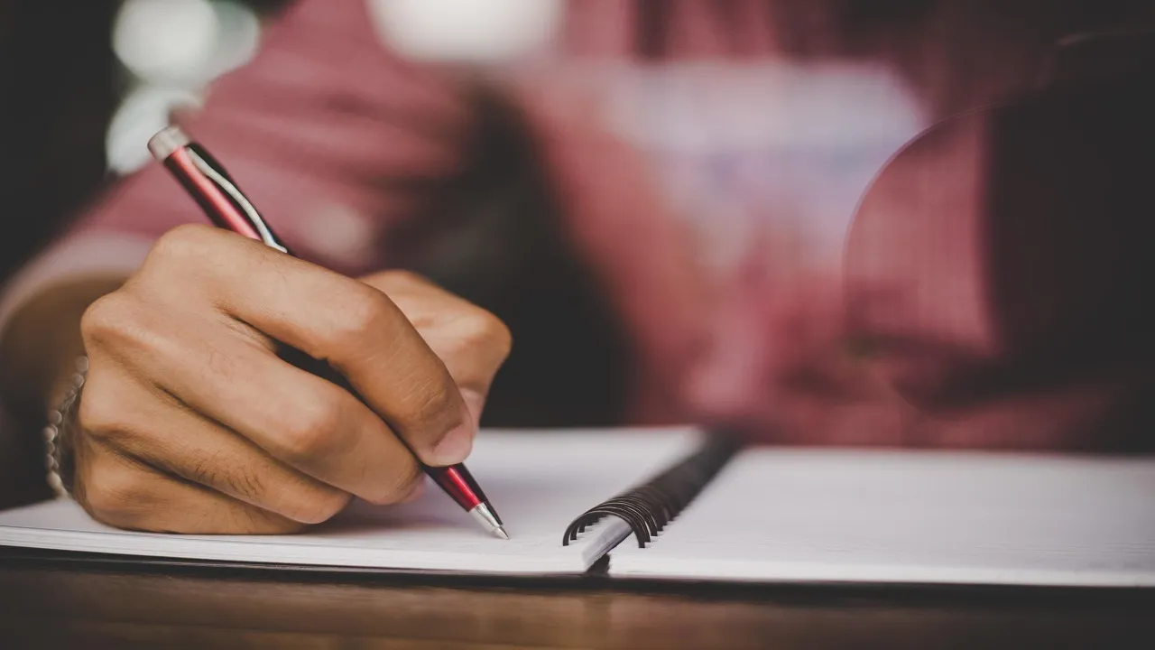 hipster right hand writing on notebook free photo