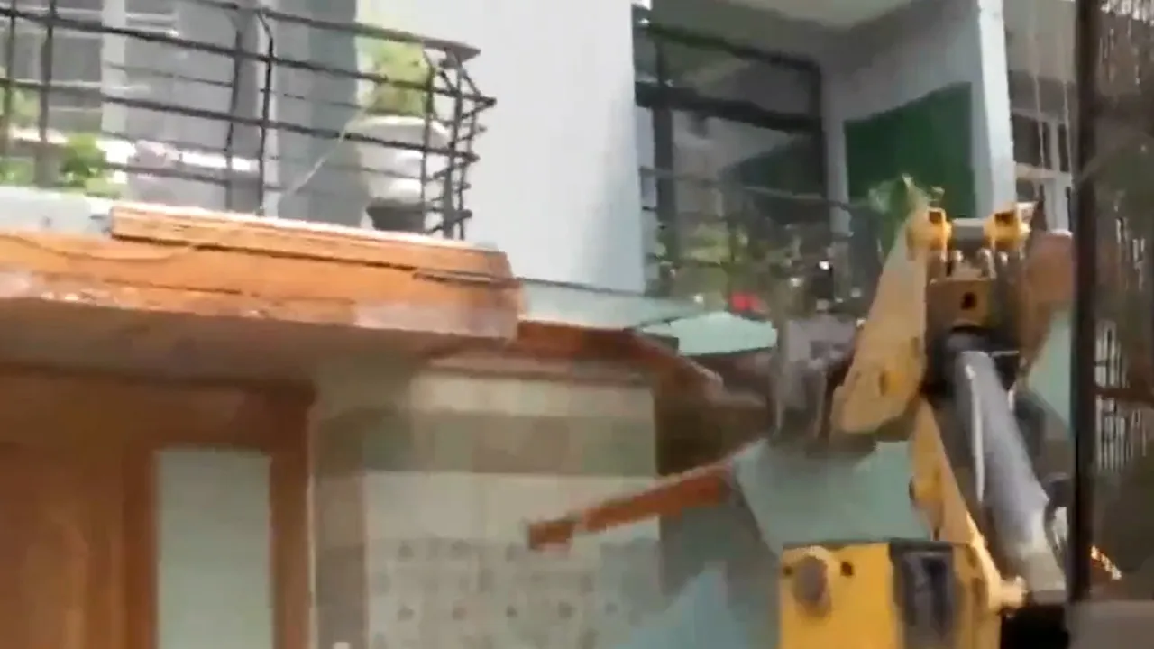 Bulldozer demolishing encroached area of Shrikant Tyagi flat