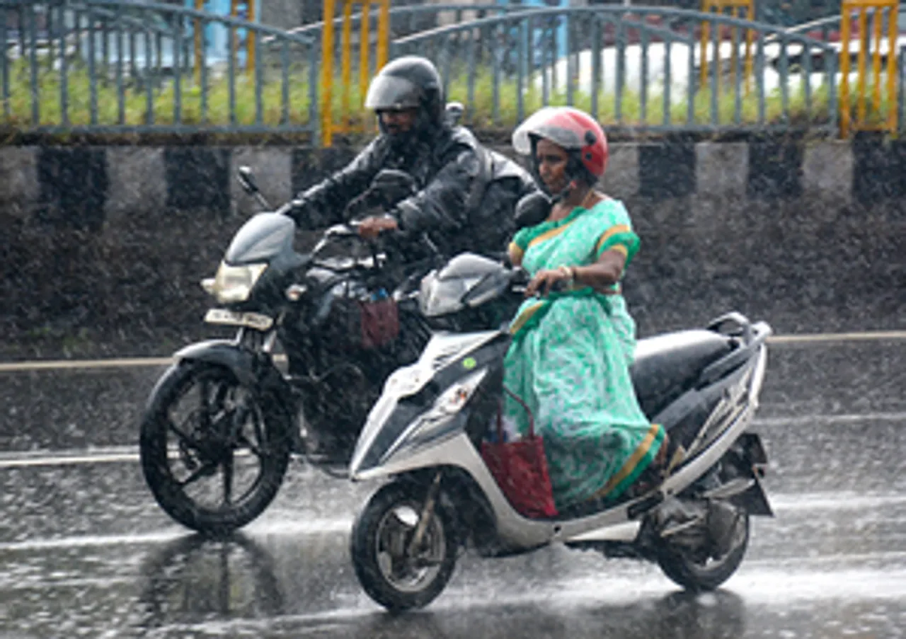 Chennai: People ride their two-wheelers amid heavy rainfall