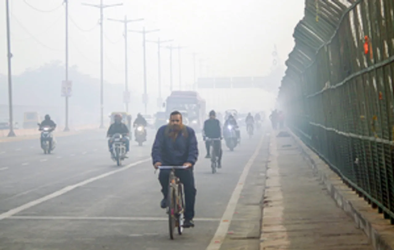 New Delhi: Vehicles move through a thick grey haze blanketing the city on a winter morning