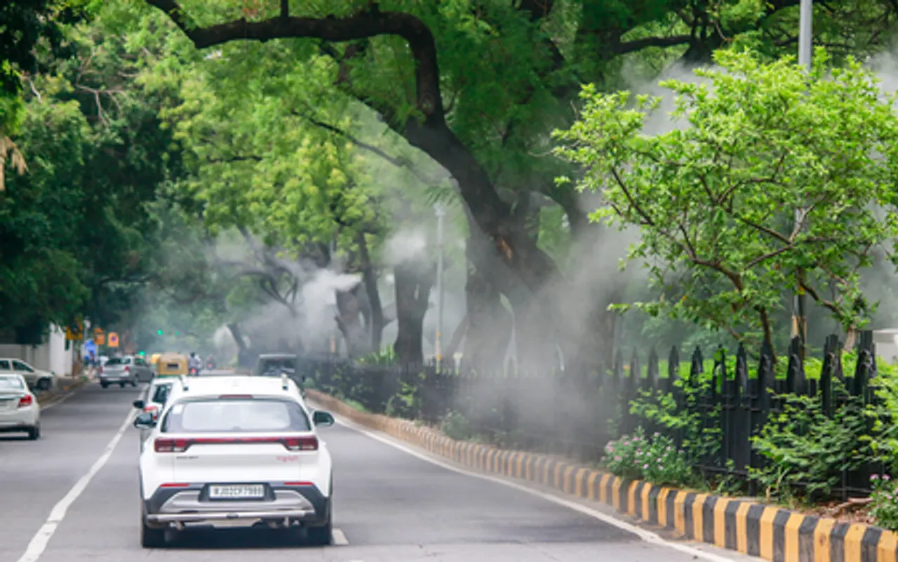 New Delhi: Mist Sprayers in Action as Commuters Pass Along Lodhi Road