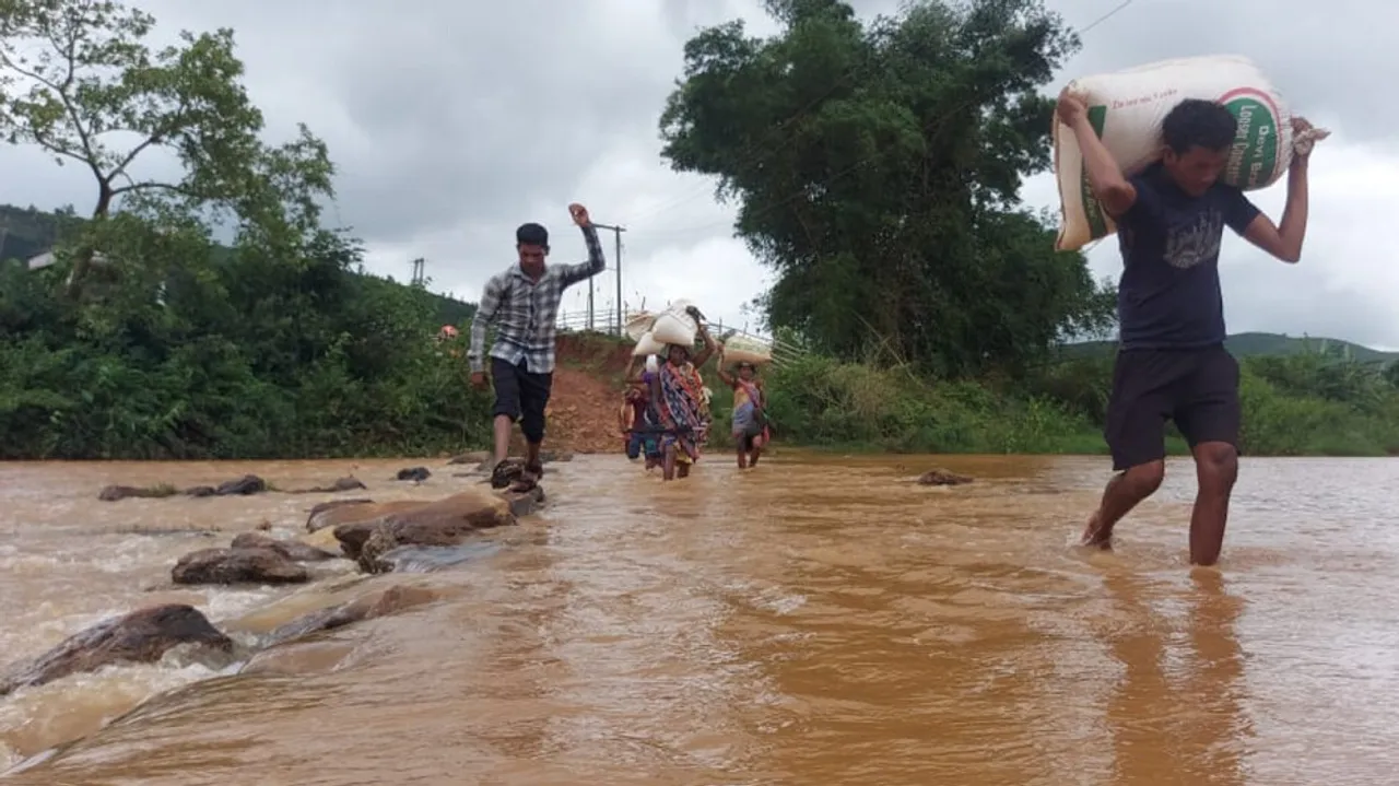 people cross river at risk of life