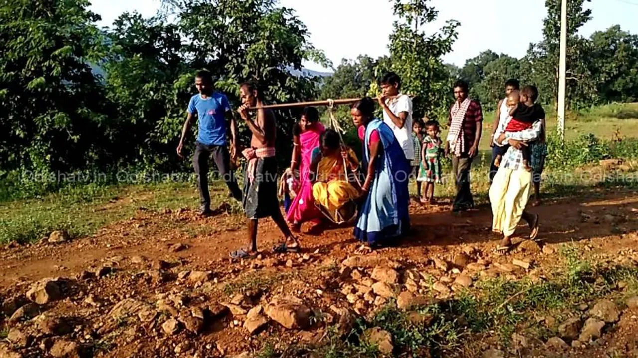 Poor road deters healthcare as expectant mother carried on sling