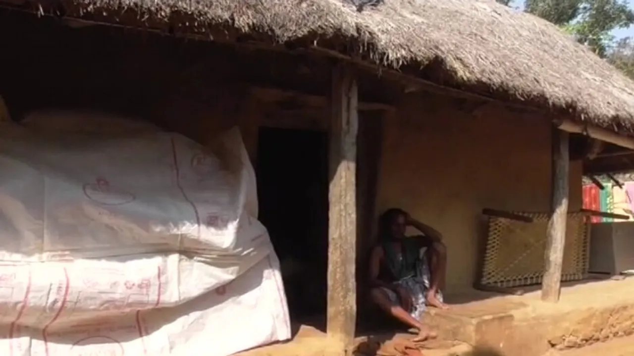 Elderly Man In A Thatched House