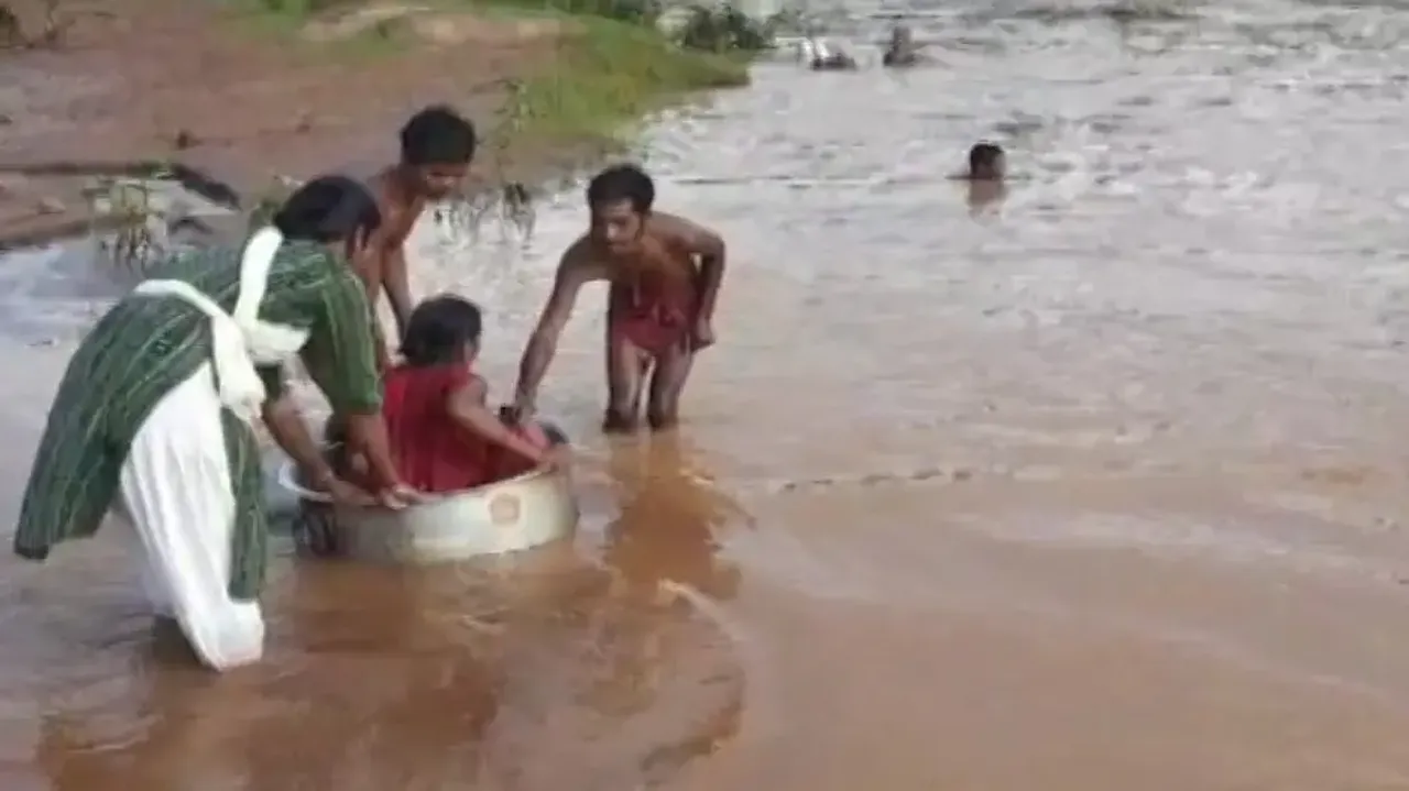 No bridge, pregnant woman crosses flooded river on cooking vessel in Koraput